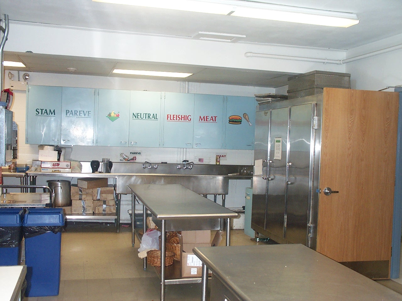 secondary view of the kitchen with labeled cabinets